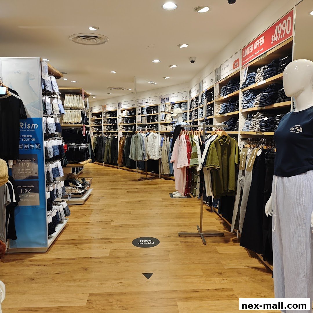 Interior view of a Uniqlo store showcasing clothing displays and a mannequin.