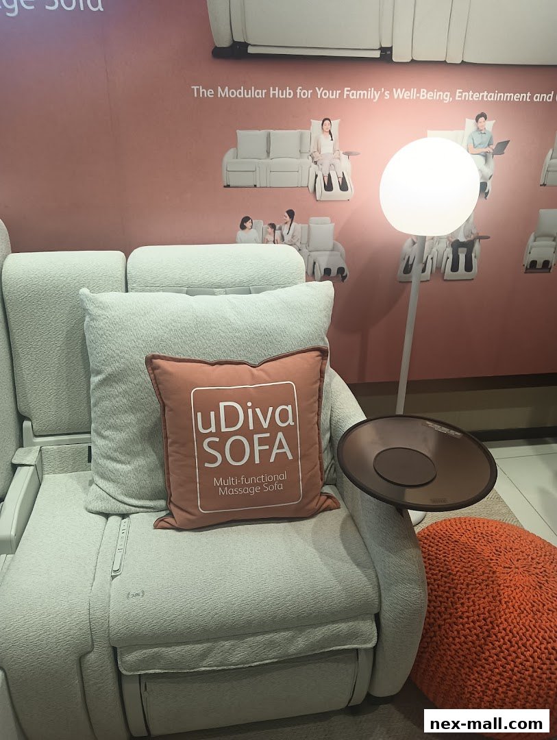 A close-up of a light-colored, multi-functional massage sofa with a decorative pillow.