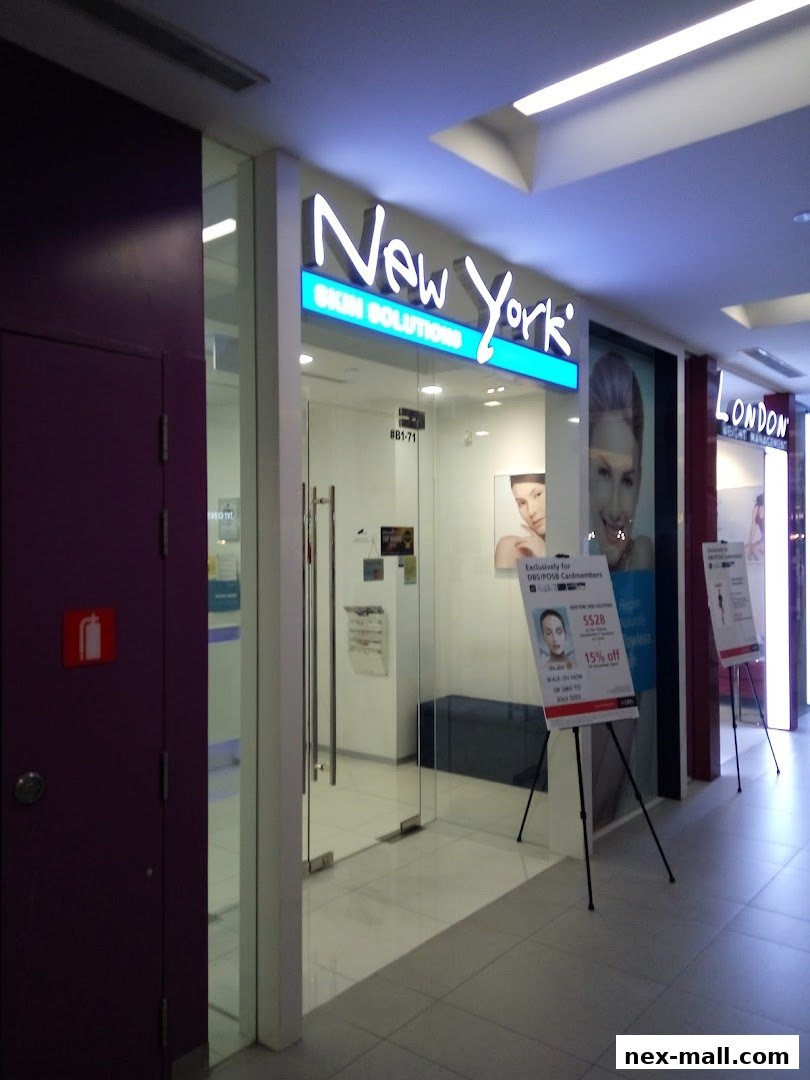 The entrance to New York Skin Solutions, a facial treatment expert, with promotional posters outside.