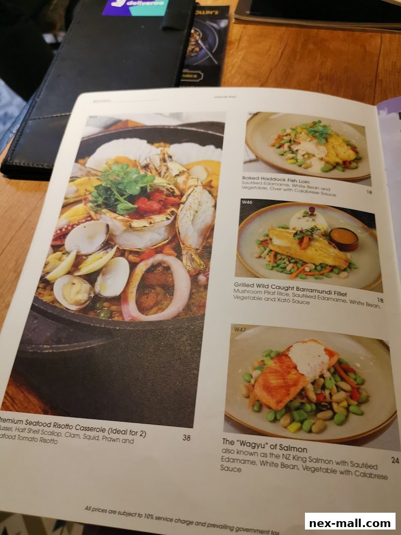 A menu page from COLLINS NEX featuring seafood dishes and salmon.