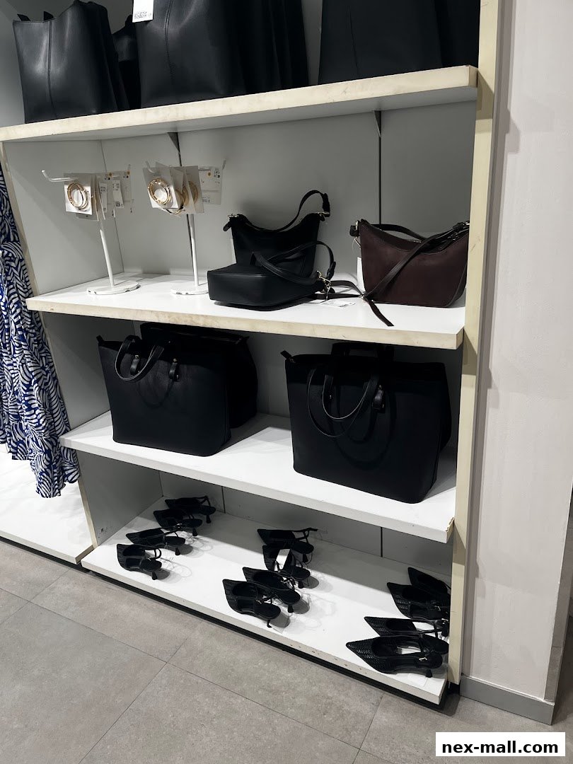 Shelves display handbags, jewelry, and shoes in a retail store.