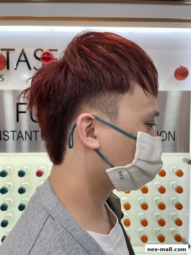 A person with red hair and a mask is shown in profile, with decorative balls and product displays in the background.