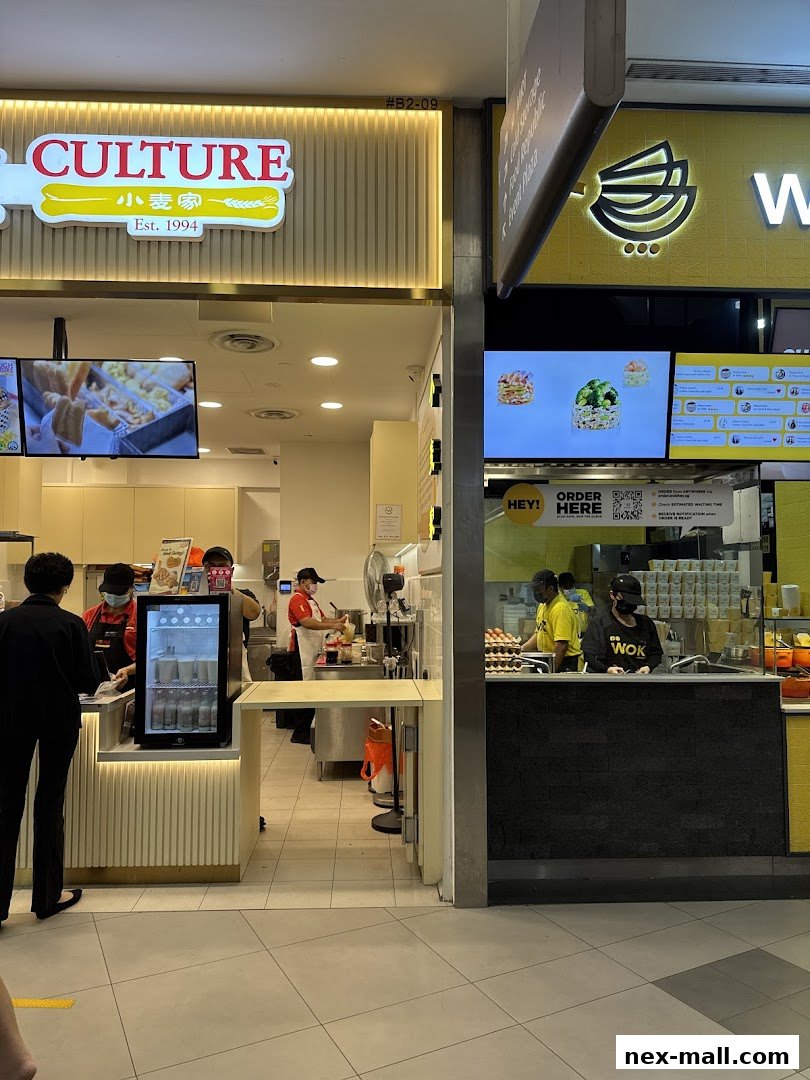 The entrance of Dough Culture and a neighboring food stall with staff preparing food.
