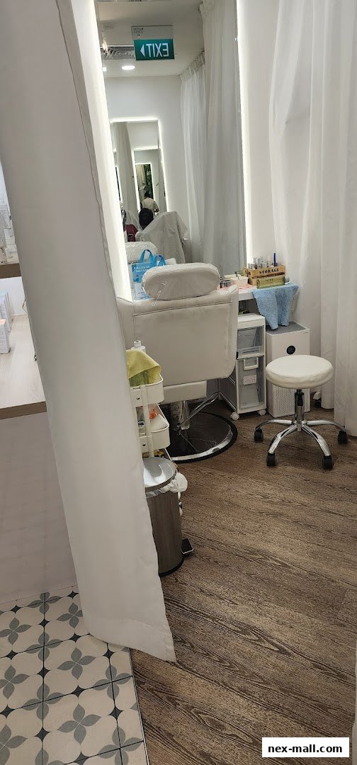 Interior shot of a clean and modern beauty salon with a pedicure chair and supplies.
