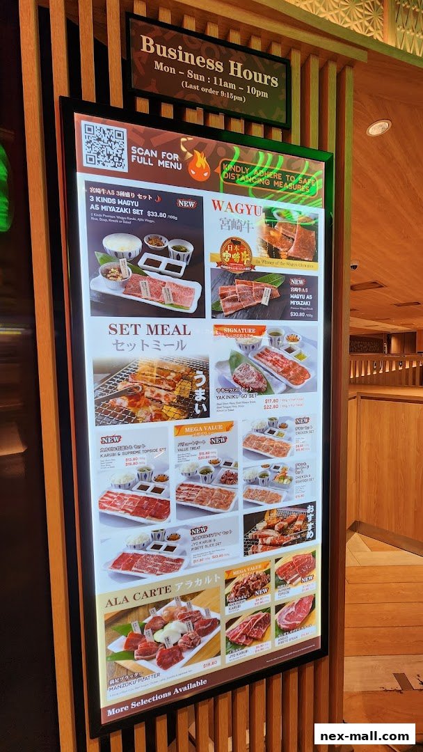 A digital menu board displaying various Wagyu beef set meals and a la carte options.
