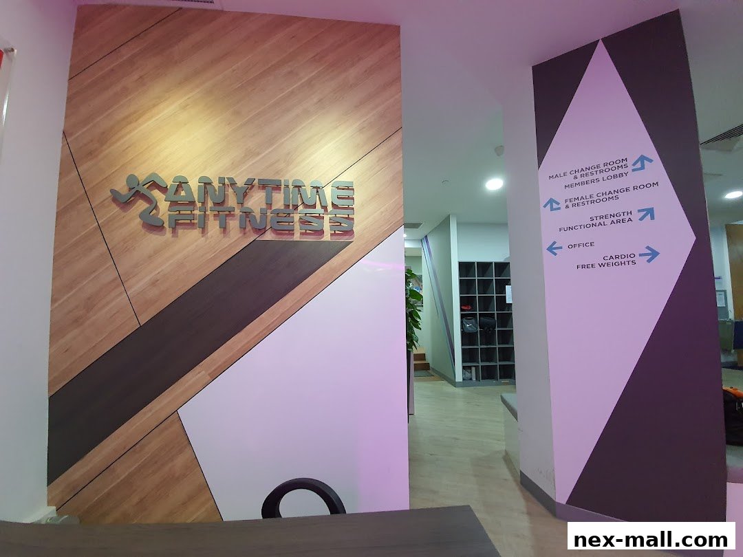 Interior view of Anytime Fitness NEX showing the gym's logo and directional signage.