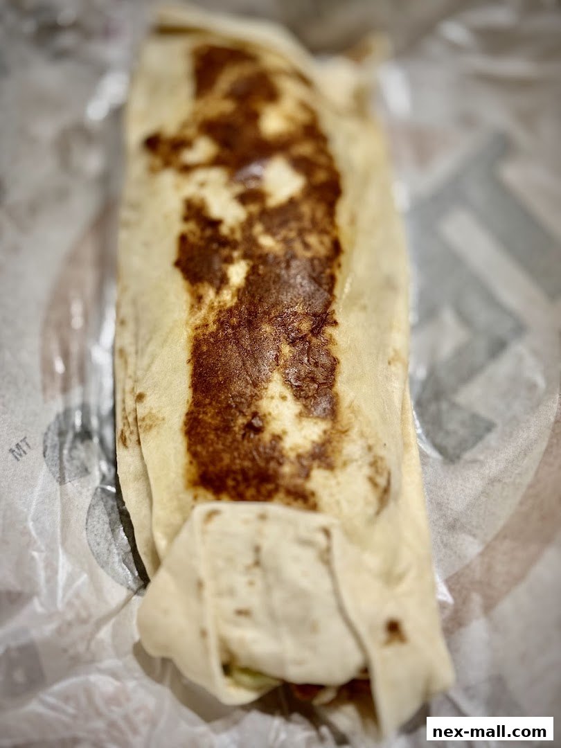 A close-up shot of a grilled chicken wrap from Texas Chicken NEX.