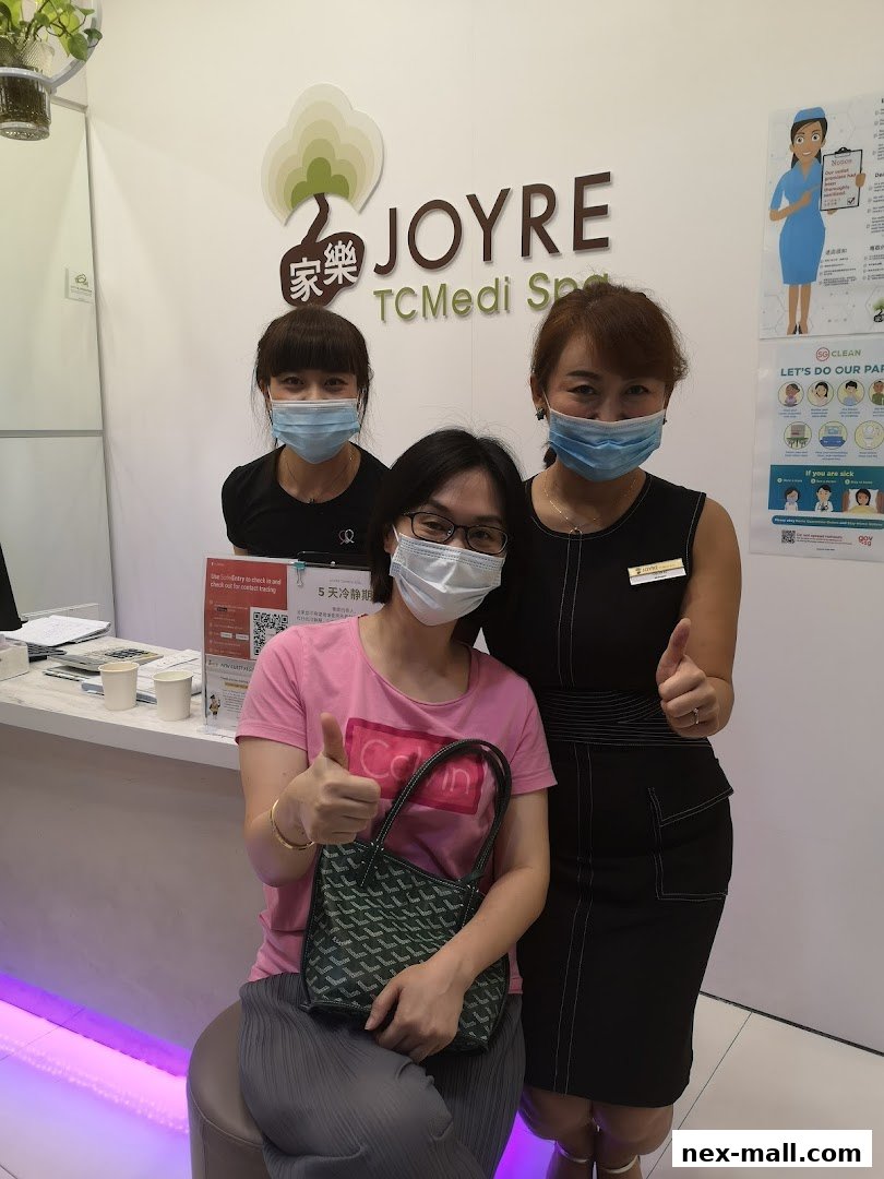 Three women, two staff and one customer, pose for a photo at Joyre TCMedi Spa.