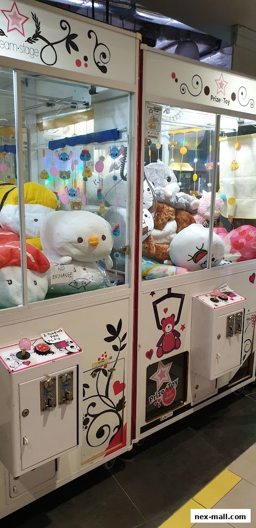 Two prize claw machines filled with plush toys, including Stitch and various cute characters.