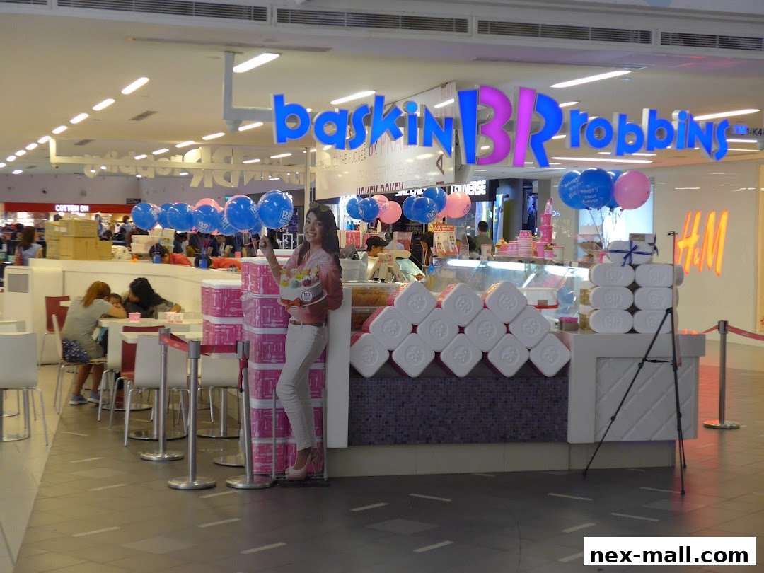 Baskin-Robbins ice cream shop with colorful balloons and a cutout of a woman holding ice cream.