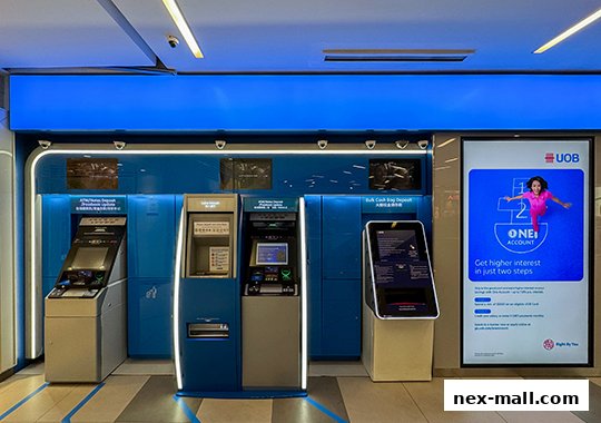 UOB bank branch with multiple ATMs and a digital advertisement for a ONE Account.