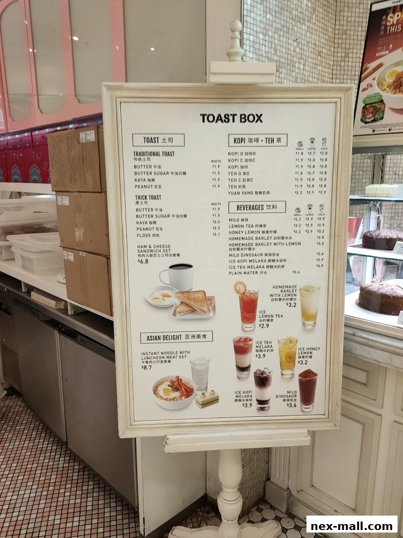A menu board for Toast Box NEX, featuring traditional and thick toasts, beverages, and Asian delights.