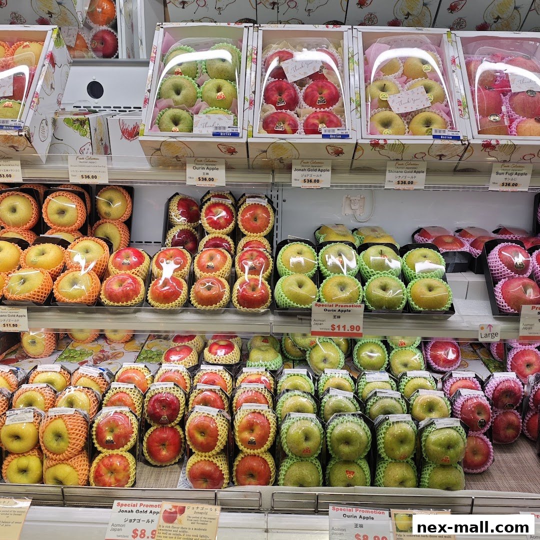 A display of various types of apples and pears, neatly packaged and presented for sale.