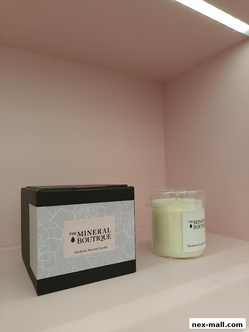 A boxed and unboxed gardenia scented candle from The Mineral Boutique.