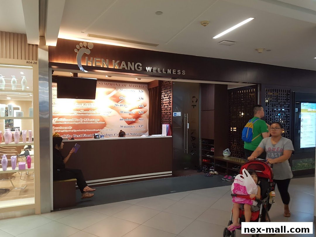 The entrance of Chen Kang Wellness, a massage and footology center, with a price list displayed.