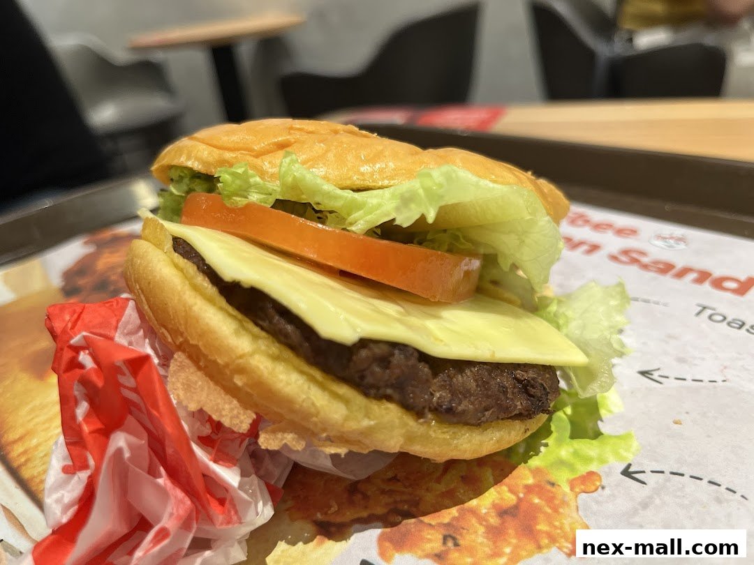 A close-up shot of a delicious Jollibee burger with fresh lettuce, tomato, and cheese.