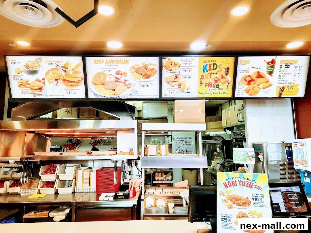 A view of the interior of Texas Chicken NEX, showing menu boards and food preparation areas.
