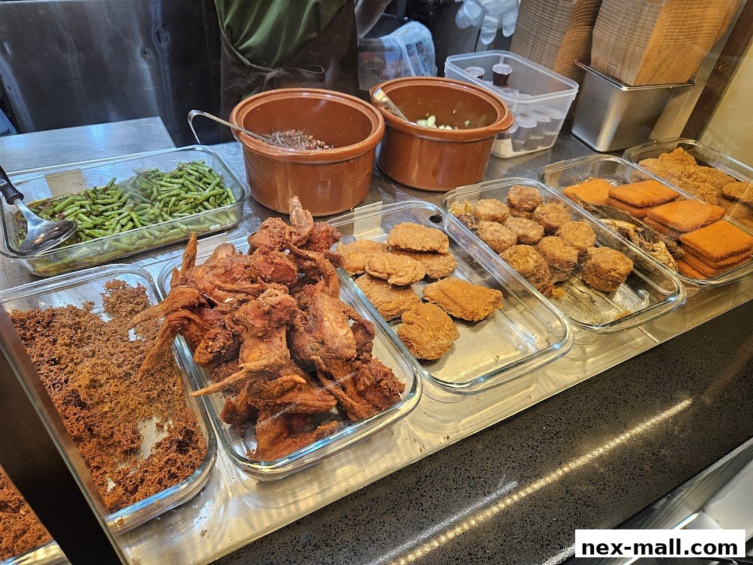A display of various fried foods and side dishes, including chicken wings and green beans.