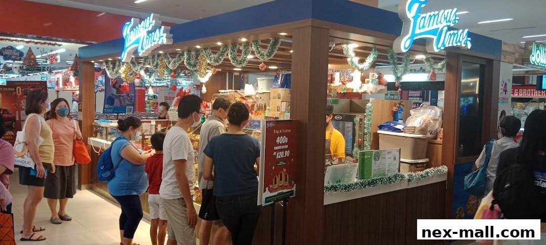 A Famous Amos cookie store with customers queuing, decorated for Christmas.