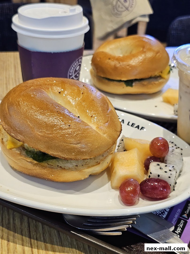 Two bagels with fruit and coffee cups from The Coffee Bean & Tea Leaf.