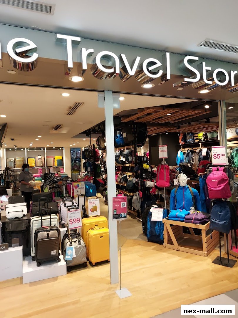 The Travel Store entrance showcasing various luggage and backpacks with price tags.