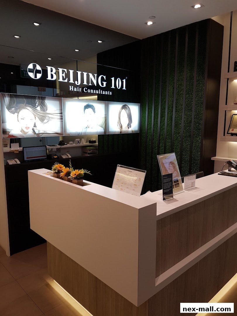The reception area of Beijing 101 Hair Consultants with a modern counter and illuminated signage.