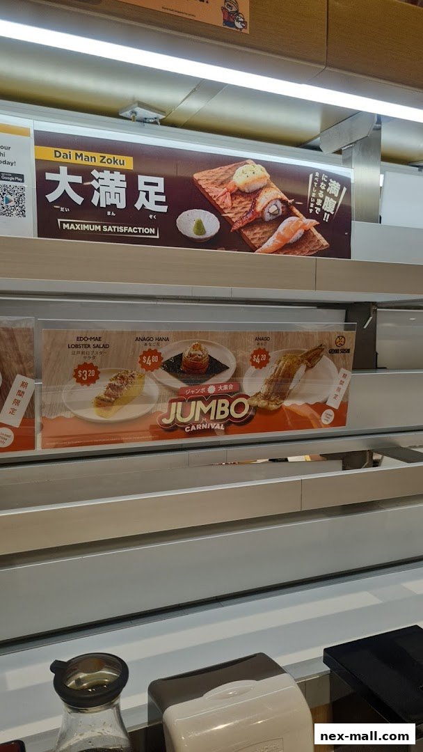 A display of sushi dishes and promotions at Genki Sushi NEX.