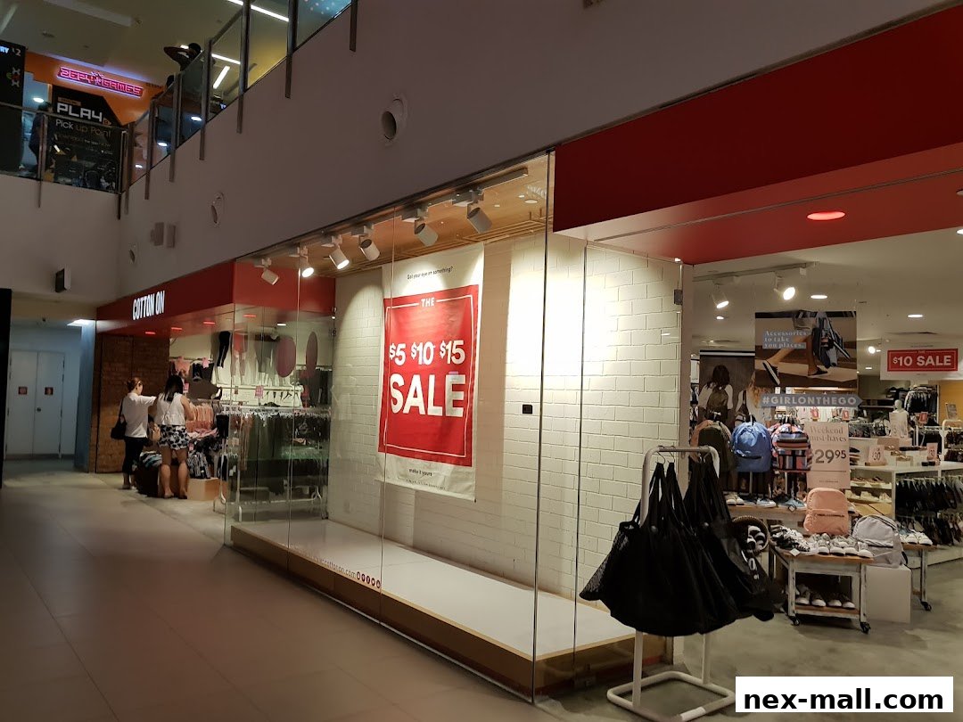 Cotton On store with a large sale banner and various clothing and accessories displayed.
