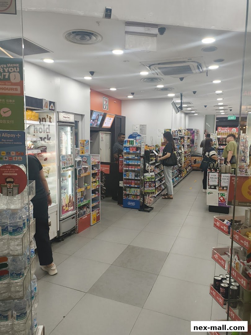 Interior view of a 7-Eleven convenience store with customers and merchandise.