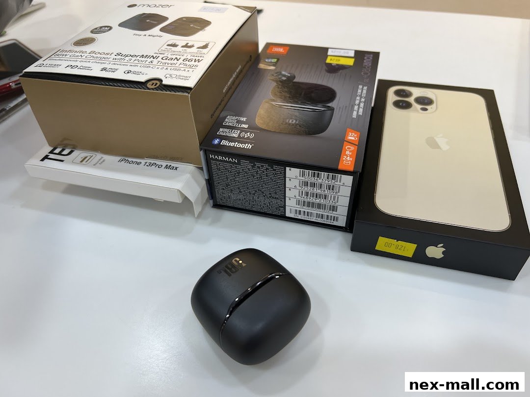 Various electronic devices including an iPhone, JBL earbuds, and a multi-port charger.