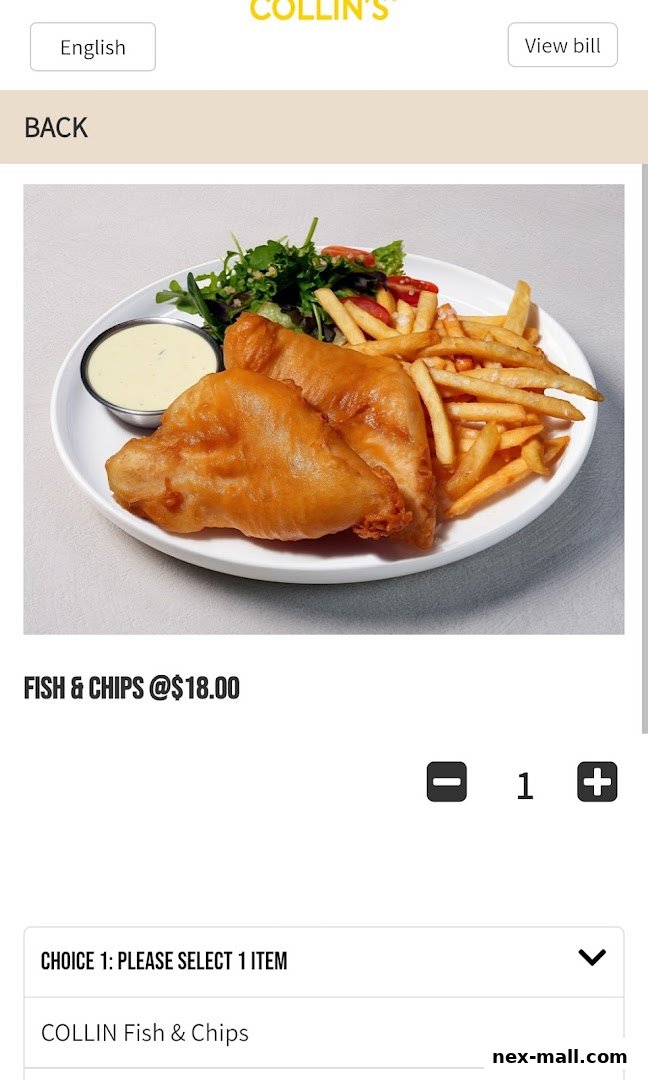 A delicious plate of fish and chips with a side salad and dipping sauce.