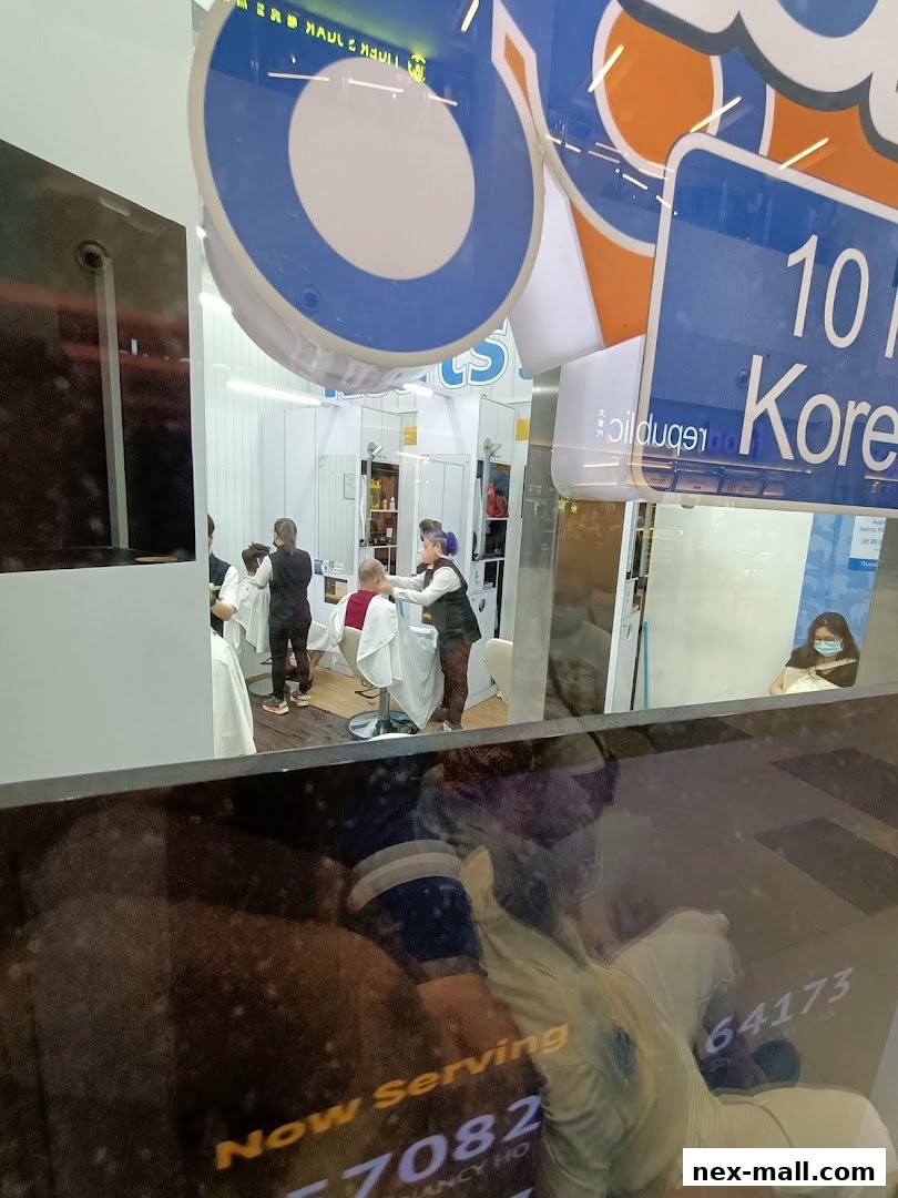 A hair salon interior with stylists cutting customers' hair, viewed through a reflective window.