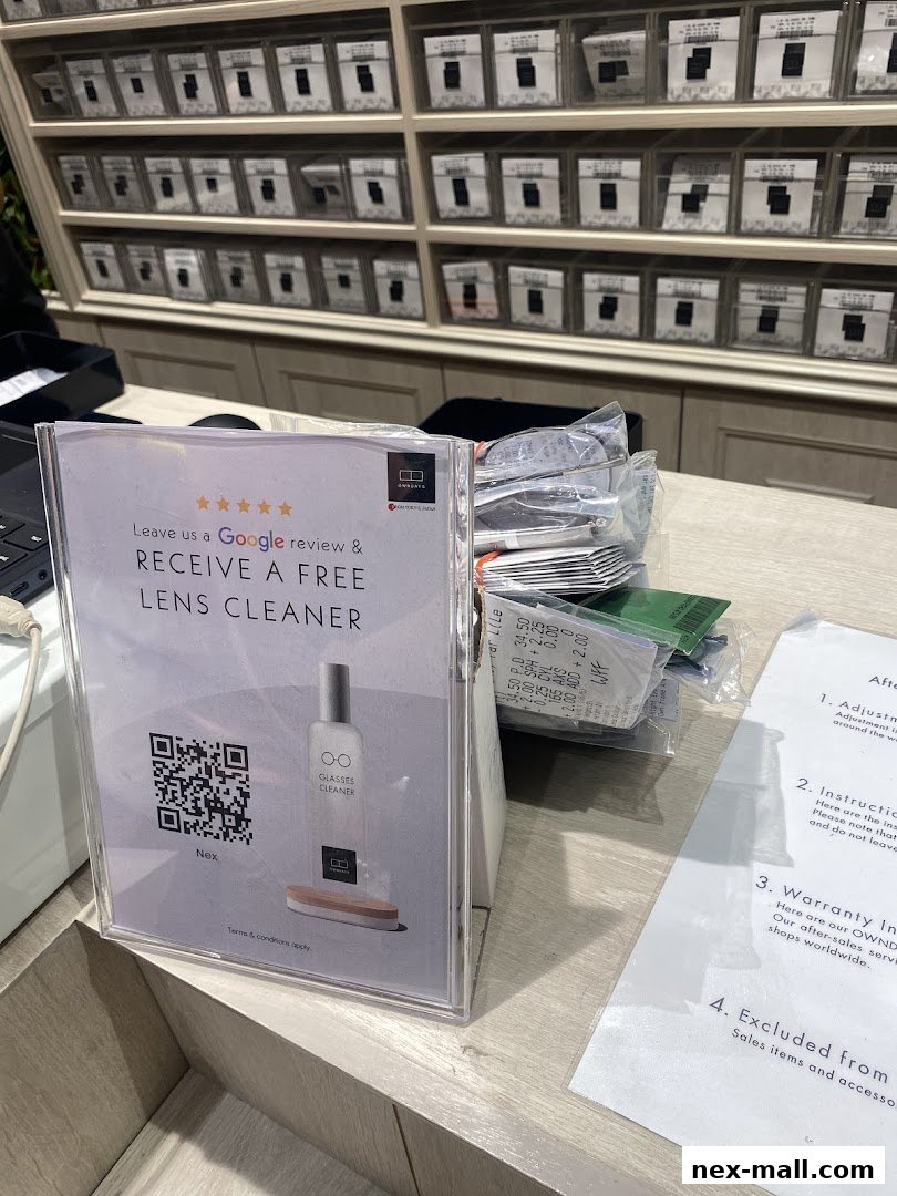 A sign offering a free lens cleaner for a Google review at OWNDAYS nex.