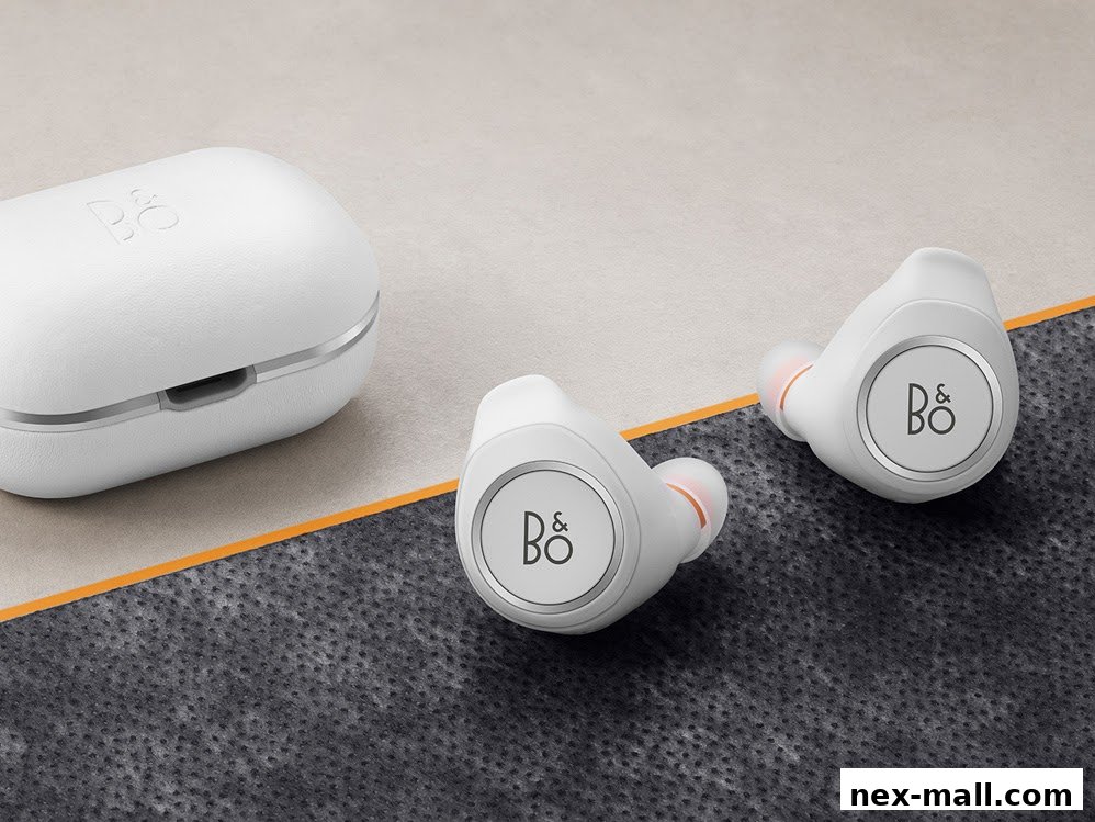 A pair of white wireless earbuds and their charging case with the B&O logo.