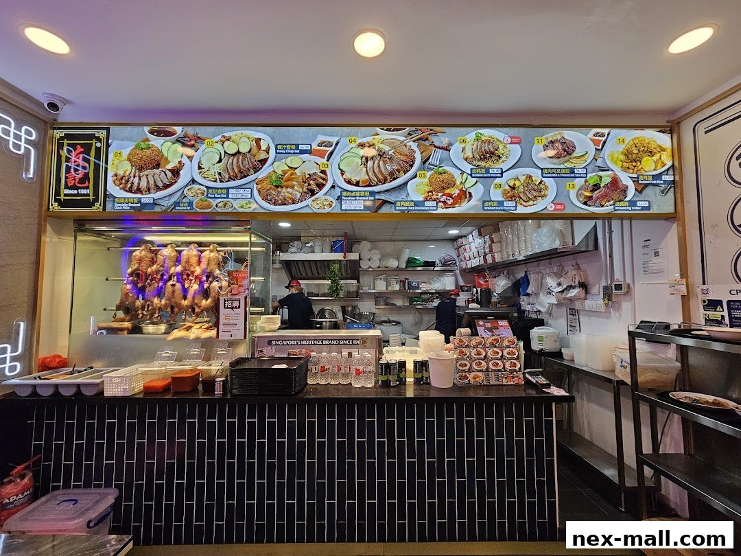 A food stall with a display of roasted ducks and a menu board showing various dishes.