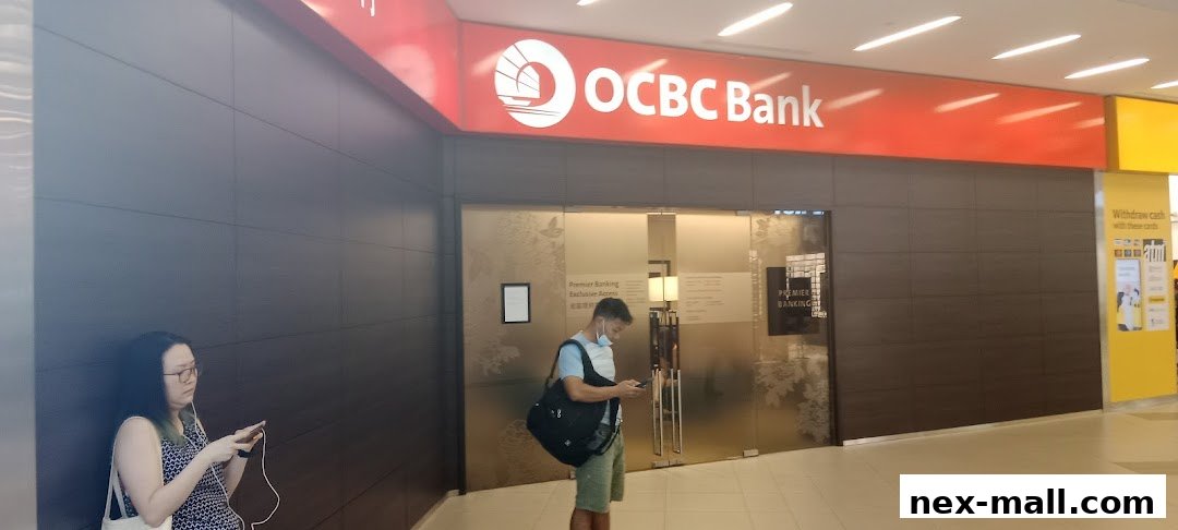 The OCBC Bank entrance with a sign and people waiting outside.