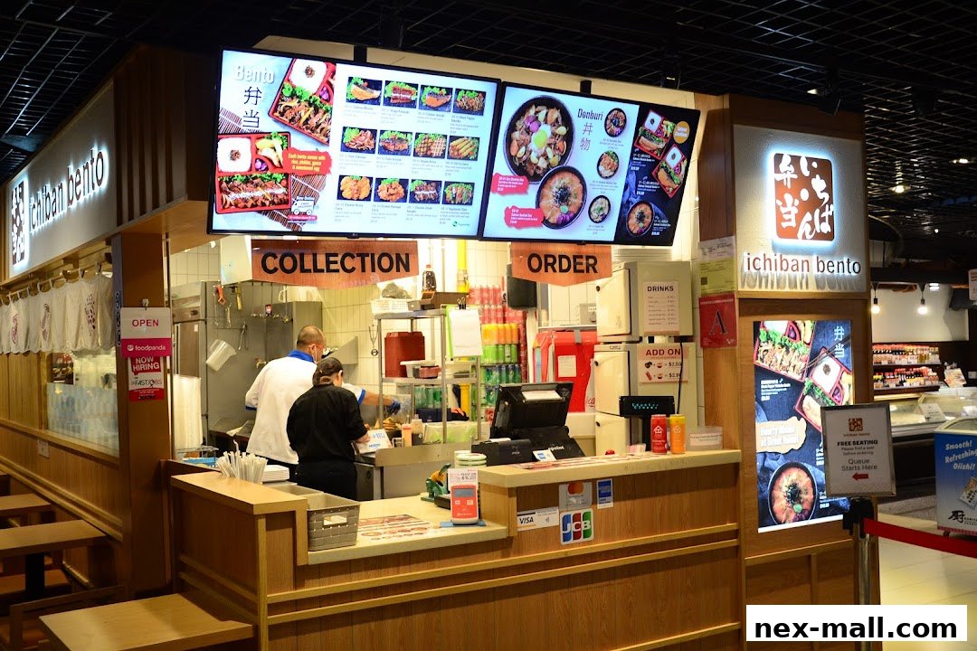 A Japanese food stall with digital menus displaying bento boxes and donburi.