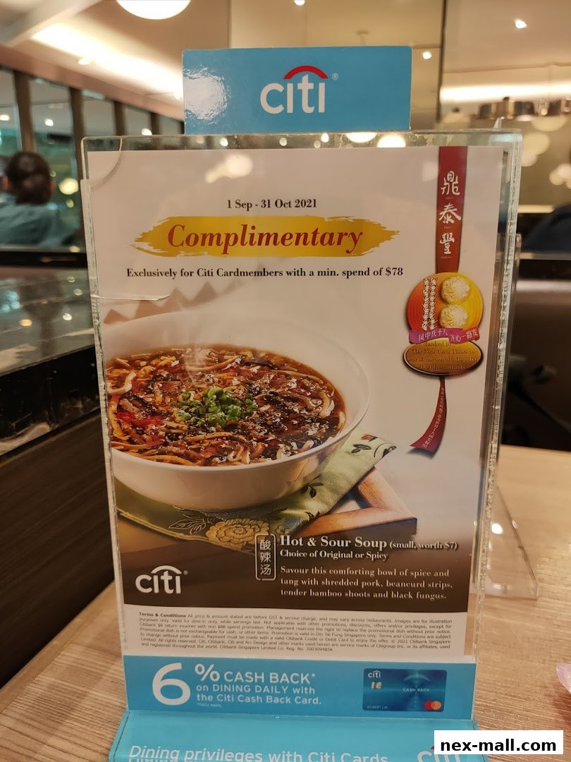 A promotional sign for Din Tai Fung offering complimentary Hot & Sour Soup for Citi Cardmembers.
