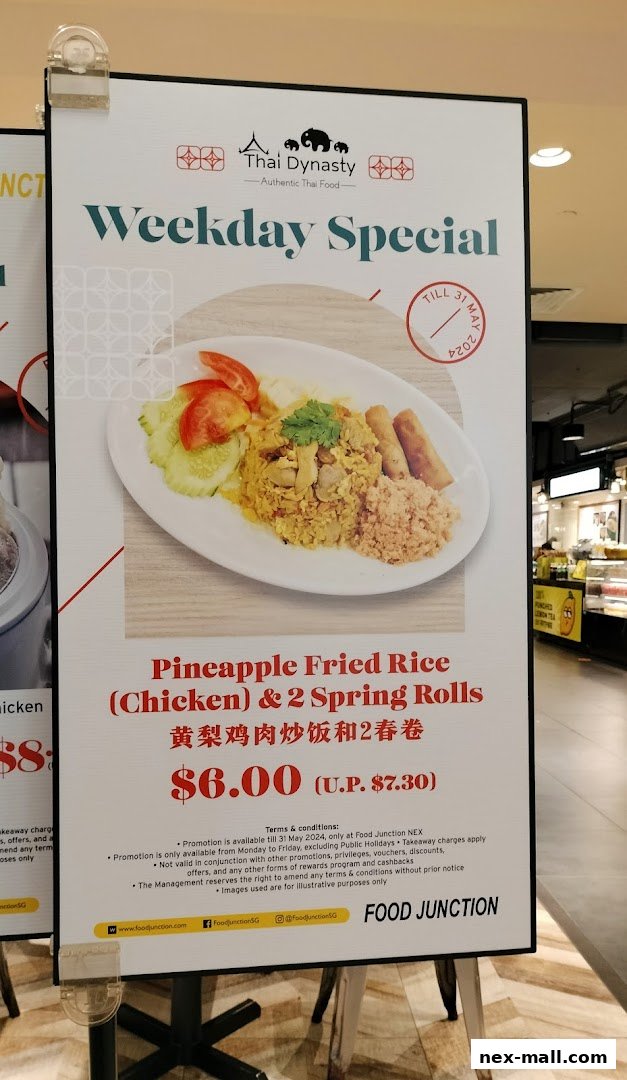 A sign advertising a weekday special for Pineapple Fried Rice with chicken and spring rolls.