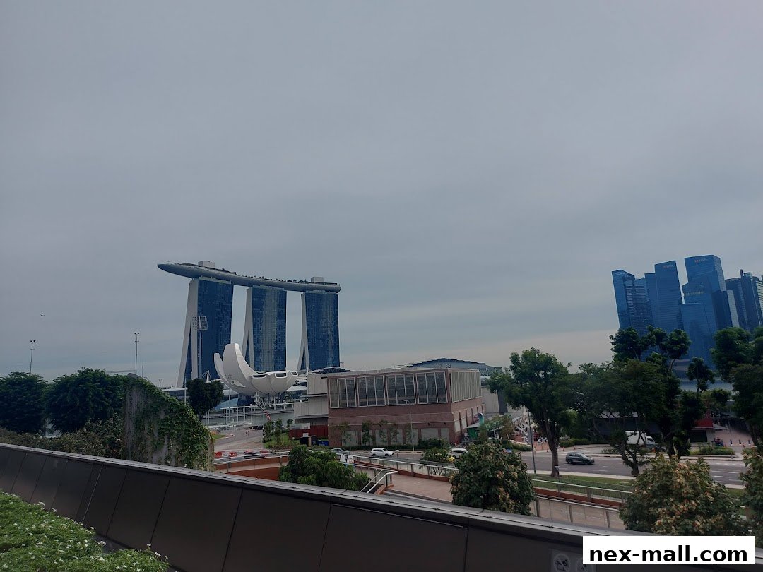A cityscape view featuring Marina Bay Sands and modern skyscrapers under a cloudy sky.