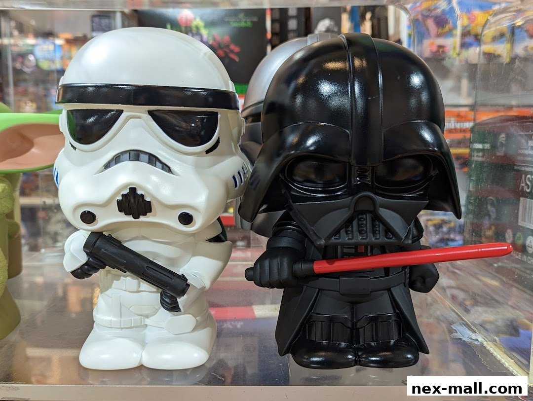 Two stylized Star Wars characters, Darth Vader and a Stormtrooper, are displayed in a shop.