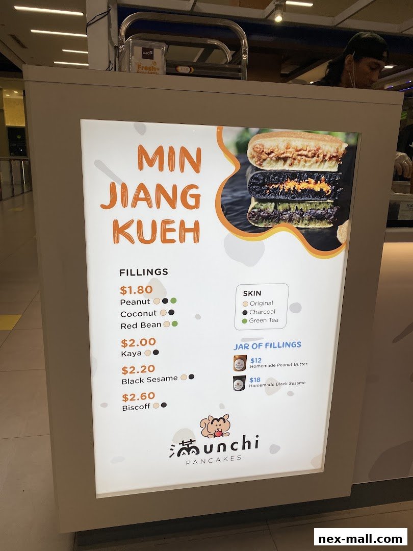 A menu board for Munchi Pancakes showcasing Min Jiang Kueh fillings and jarred fillings.