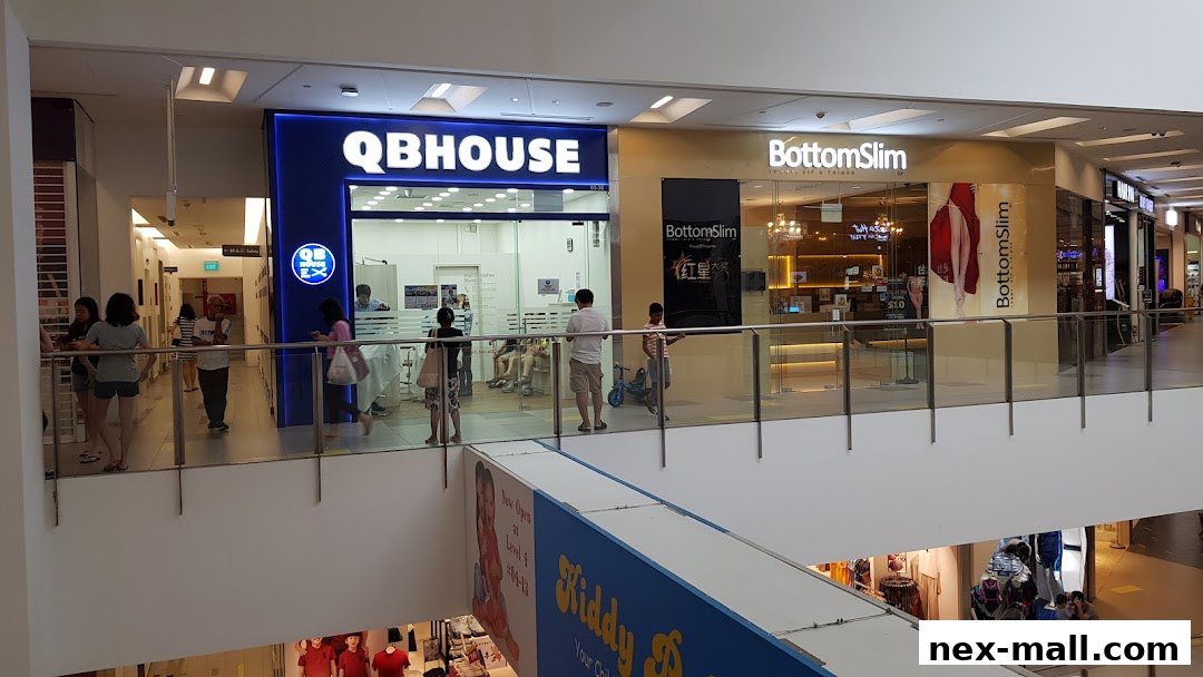 The QB HOUSE NEX shop front with customers inside and waiting.