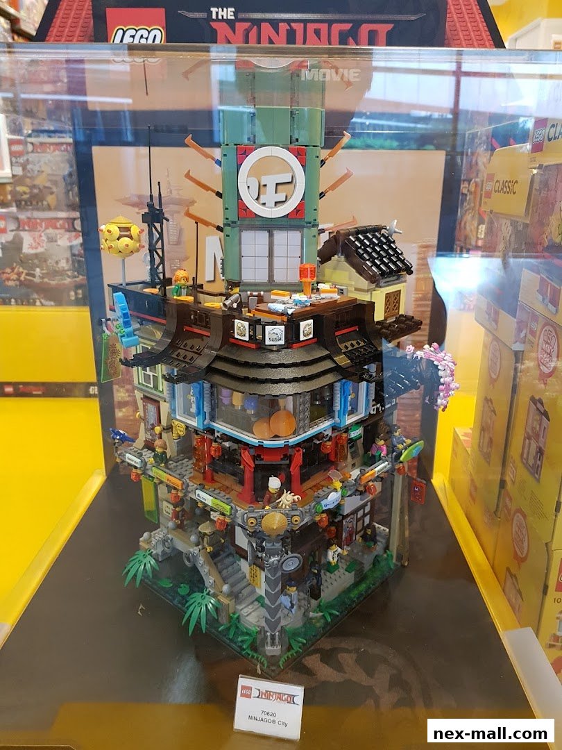 A detailed LEGO Ninjago City model displayed in a store window.