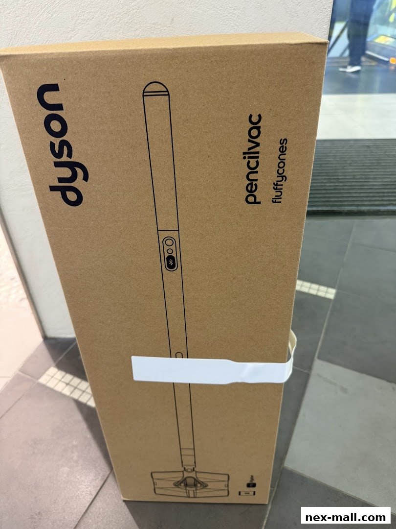 A cardboard box for a Dyson pencil vacuum cleaner with a fluffy brush attachment.