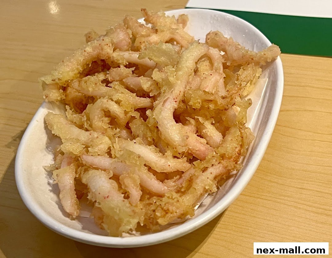 A white bowl filled with crispy, golden-brown fried calamari rings.