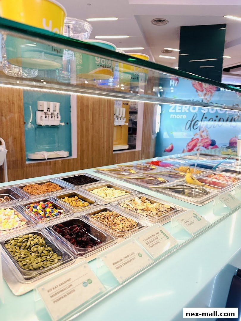 A display of frozen yogurt toppings and dispensers at Yolé Nex.