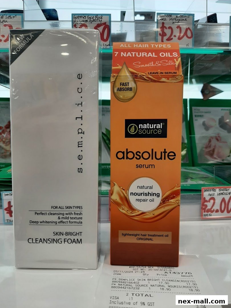 Two beauty products, a cleansing foam and a hair serum, displayed on a shelf with price tags.