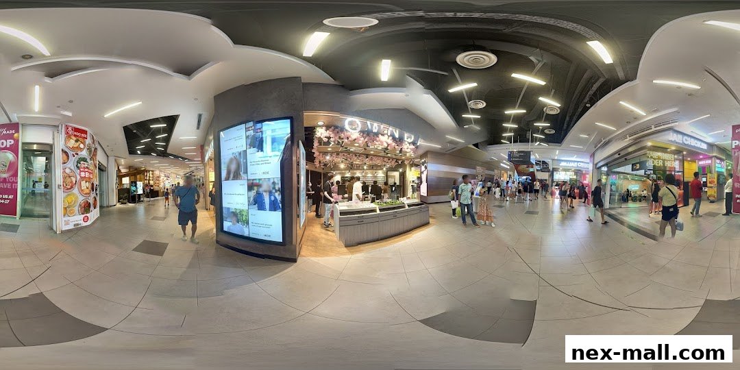 A panoramic view of a shopping mall corridor with the OWNDAYS glasses shop prominently featured.