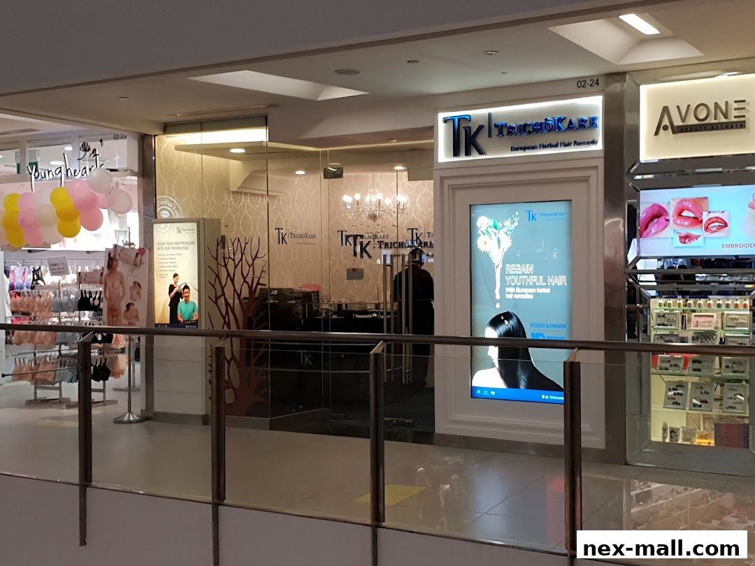 The exterior of TK TrichoKare, a hair loss and scalp treatment shop, with adjacent stores visible.